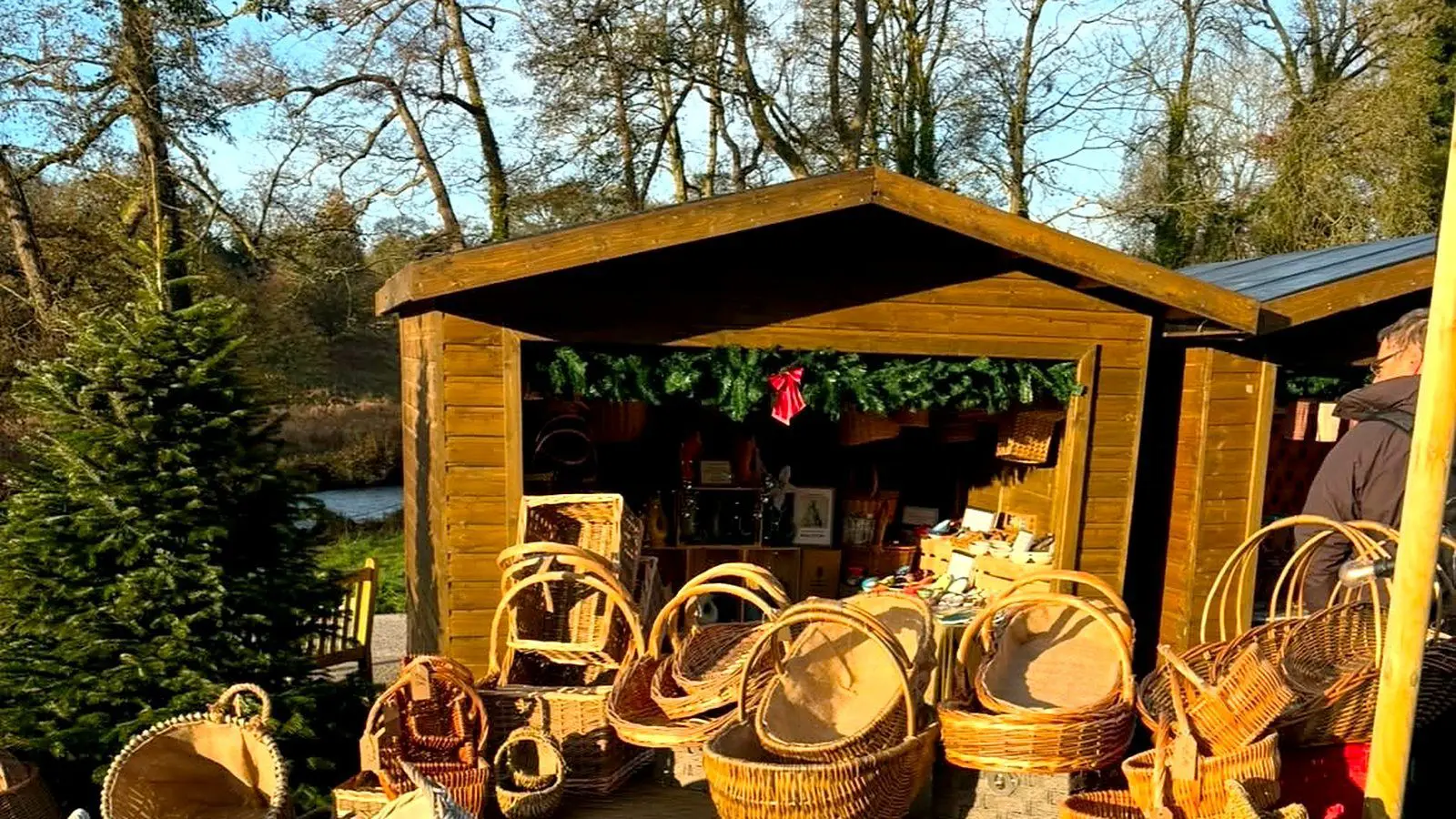 The Peak Sales market hut with willow log baskets and trugs stacked out front