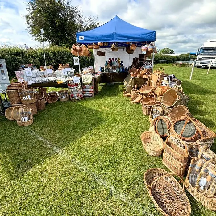 Willow baskets laid out on the grass beside the Peak Sales gazebo