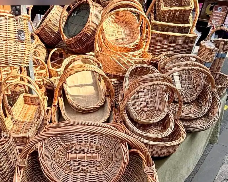 Willow garden trugs and round baskets piled on the market stall