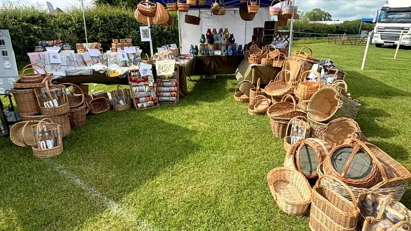 The Peak Sales gazebo on a show field with willow baskets laid out on the grass
